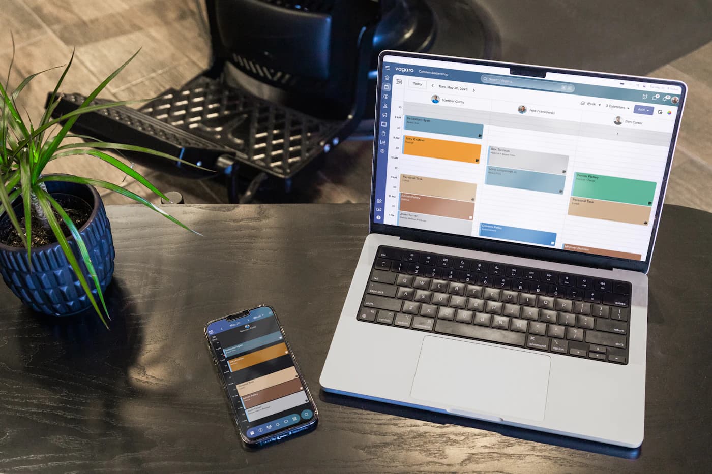 A laptop and phone showing a small-business appointment calendar