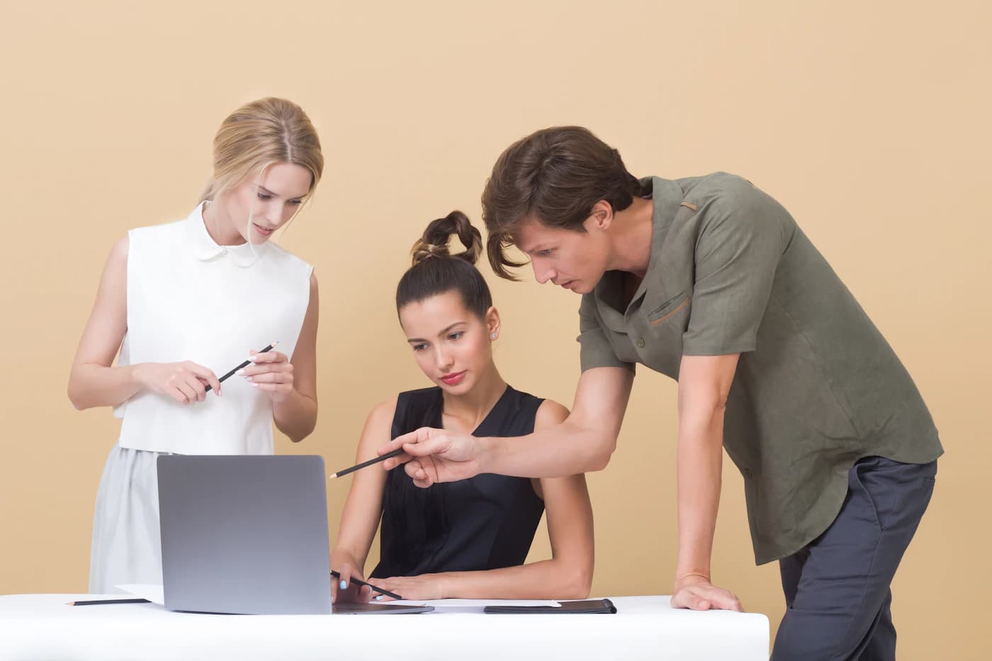 Two colleagues reviewing a project together on a laptop